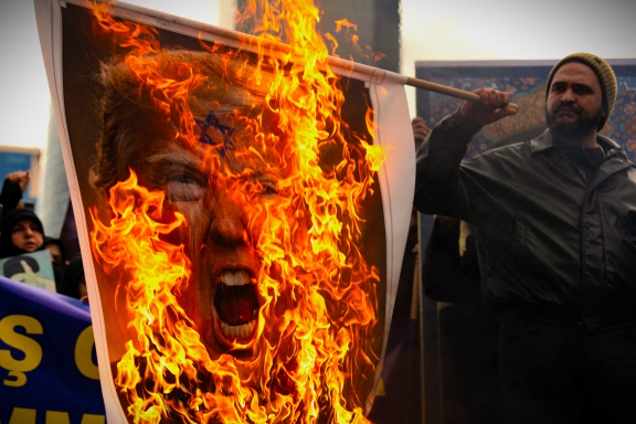 Une photo du président américain Donald Trump incendiée, le 1er mars, lors d'une manifestation devant le consulat israélien à Istanbul, après l'annonce de la mort de l'Ayatollah Khamenei (photo Robert Badendieck/Middle East Images/AFP). 